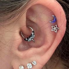 an ear with three different piercings on it