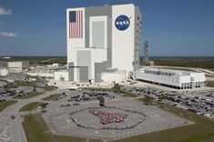 an aerial view of the space shuttle assembly building with flags on it's side