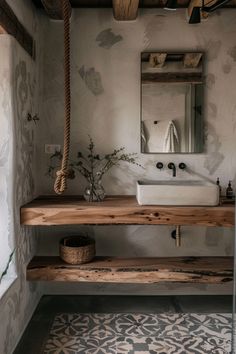 a bathroom with a sink, mirror and wooden shelf