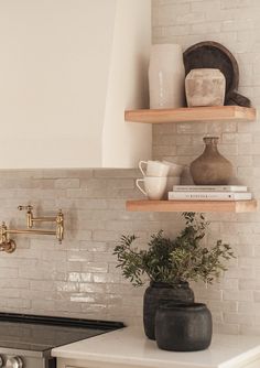 the kitchen counter is clean and ready to be used as a shelf for pots, mugs, and other items