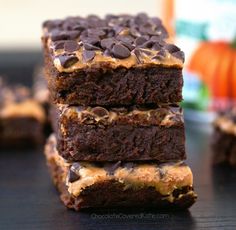 three brownies stacked on top of each other with chocolate chips and peanut butter in the middle