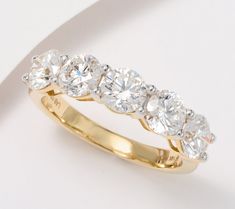 a five stone diamond ring on a white background