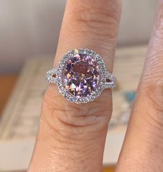 a close up of a person's hand with a ring on top of it