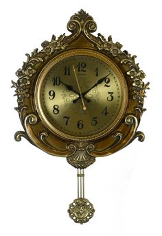 an ornate gold clock with roman numerals on the face and hands is shown against a white background