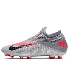 the nike vapor soccer shoe is shown in grey and infrared pink tones, with red accents