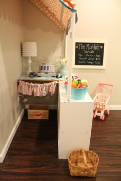 there is a small refrigerator in the corner of this room with baskets on the floor