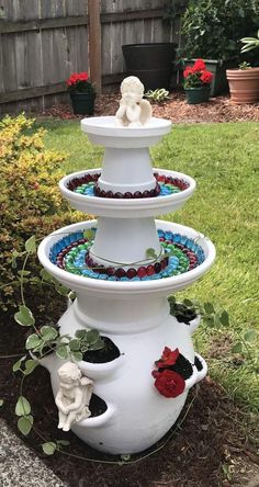 three tiered water fountain in the garden