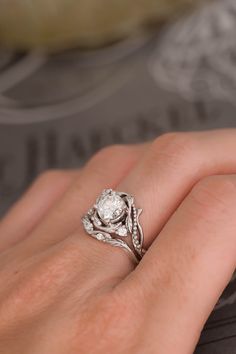 a woman's hand with a diamond ring on it