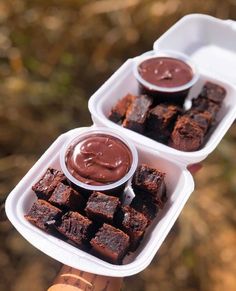 two plastic containers filled with brownies and dipping sauce