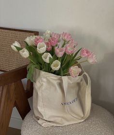 pink and white tulips in a tote bag on a chair