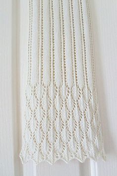 a white crocheted curtain hanging on the side of a door