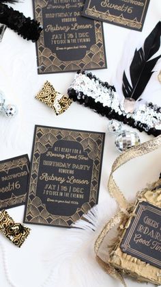 black and gold wedding stationery with feathers, ribbons, and confetti on the table