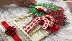 a close up of a decorated box on a table with christmas decorations and ribbon around it