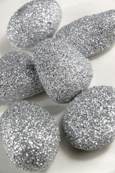 silver glitter donuts are on a white plate