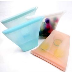 three different colored plastic containers with lids