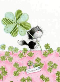 a greeting card with a cat holding a clover