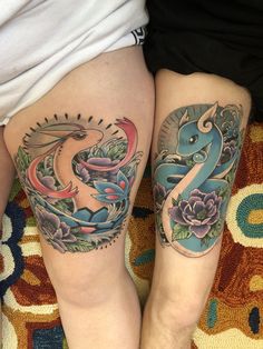 two people with tattoos on their legs sitting next to each other