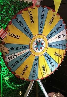 a colorful wheel of fortune sign in front of a green wall