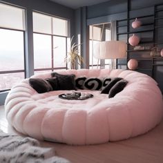 a dog bed in the middle of a room with large windows and fur rugs on the floor