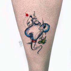 a tattoo on the leg of a person with a cat and bird in front of them