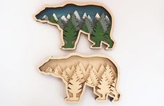 two wooden cut outs depicting bears in the woods