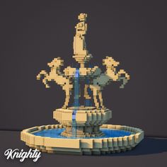 the statue is made out of legos and has blue water coming from its base