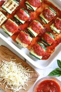 zucchini rolls with marinara sauce and parmesan cheese on the side