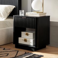 a night stand with two drawers and a lamp on the end table next to it