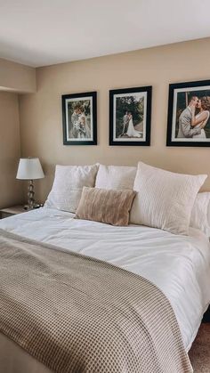 a bedroom with two framed pictures on the wall and a bed in front of it