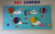 a bulletin board with hot air balloons and the words get carried on it's side