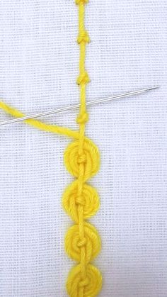 a close up of a yellow crochet stitch