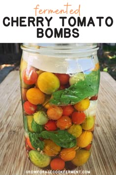 a jar filled with lots of different types of fruits and vegetables on top of a wooden table