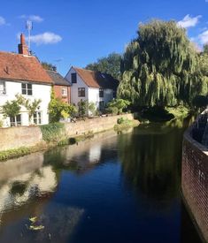 a river running through a small town next to tall buildings