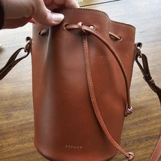 Gorgeous Classic Cognac Leather Bucket Bag. Worn Only A Couple Of Times! Like New! Https://Www.Sezane.Com/Us/Product/Farrow-Bag/Natural-Heritage#Size-Tu Bucket Bag Made In Our Italian Atelier Smooth Leather Exterior Cotton Lining Leather Handle Handle Length: 97 Cm / 38.2 In Adjustable Handle Carried On The Shoulder And Crossed Over Leather Tie Closure Zipped Pocket And Patch Pocket Inside Dimensions: 26 X 23.5 X 17 Cm / 10.2 X 9.2 X 6.7 In Leather Tie, Natural Heritage, Leather Bucket Bag, Leather Bucket, Leather Handle, Smooth Leather, X 23, Bag Making, Inside Pocket