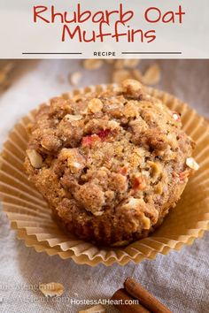 a muffin in a paper cup with cinnamon sticks