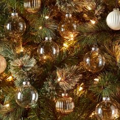 a christmas tree with ornaments hanging from it's branches