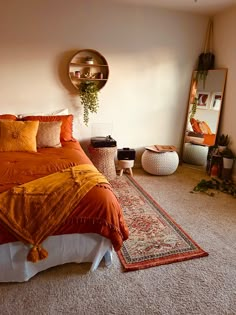 a bedroom with a bed, mirror and rugs on the floor in front of it