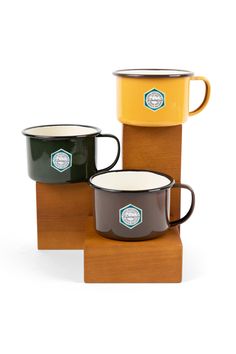 three different colored mugs sitting on top of each other