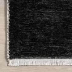 a black and white rug with fringes on it