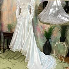 a white wedding gown on display in front of a lamp and table with vases