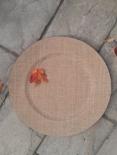 a table that has some leaves on it and is sitting on the ground next to other items