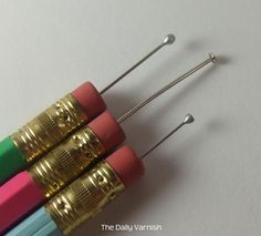 four different colored pencils sitting on top of each other