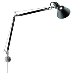 a black lamp on a white background with the light turned on and one arm down