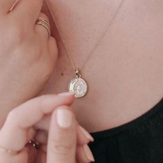 We were inspired to pay homage to our sisterhood of the world with this dainty coin disc necklace. It features the profile of a woman and is inscripted with "aime ta mère" which translates to "love your mother". A reminder to love your fellow women, mother earth, and whoever and wherever makes you feel unconditionally loved. We love it's long length to wear alone or to layer alongside your favorite necklace. It's super easy to style and wear - which is our favorite kind of necklace. This necklace features one kind artwork thoughtfully designed for us by artist, Gisela Talita. Length: Adjustable between 18" - 21". Charm: 15mm. Our materials make for an amazing, high quality, seamless, jewelry piece with longevity. Our necklaces are plated with 18k gold, 18k rose gold, or rhodium and finishe Cat Charm Necklace, North Star Necklace, Lucky Charm Necklace, Starburst Necklace, Star Necklace Gold, Mermaid Pendant, Silver Bar Necklace, Charm Necklace Silver, Gold Bar Necklace