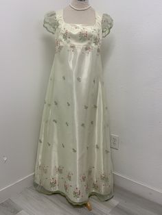 Beautiful light green organza over cream satin dress, perfect for that regency Era party or event . THERE IS NO RETURNS OR EXCHANGES ACCEPTED PLEASE BE SURE TO CHECK THE MEASUREMENTS ON THE BOTTOM OF THE DESCRIPTION. If for any reason the measurements don't match with yours be sure to provide to me at the time of order. SMALL / BUST / Length 34-36. 45 MED / 37-38. 46 LARGE /. 40/42. 47 The small dress is made with a size 10 pattern , the medium with a size 12 and the large with a size 14 . I DO Regency Debutante Dress, Spring Satin Ball Gown, Spring A-line Silk Gown, Spring Wedding Satin Gown, Spring Party Empire Waist Gown, Spring Party Gown With Empire Waist, Empire Waist Gown For Spring Party, Spring Silk Gown With Fitted Bodice, Cream Silk Party Gown