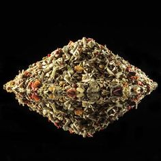 a pile of dried herbs on a black background