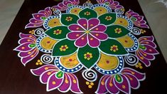 an intricately decorated wooden table top with flowers on it