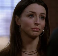 a close up of a person wearing large hoop earrings