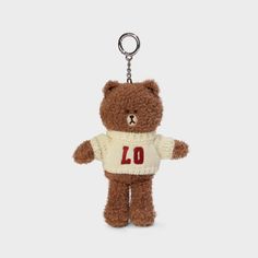 a teddy bear keychain with a sweater on it's chest and the number forty