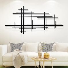 a modern living room with white couches and black lines on the wall above it